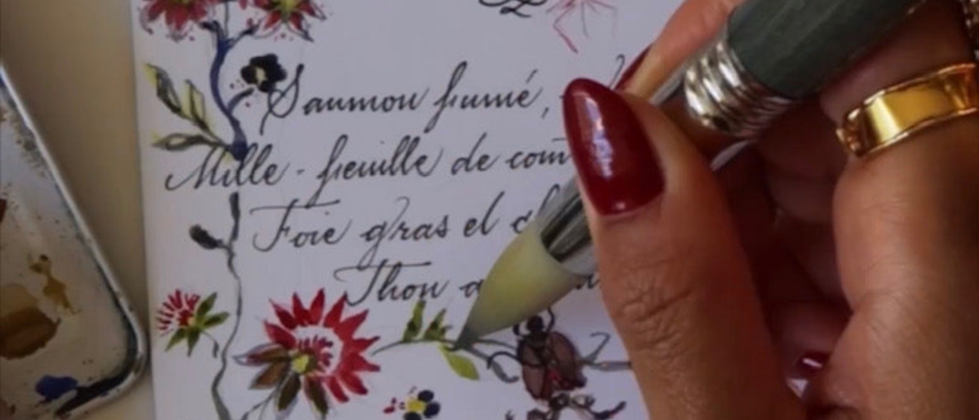 Panicha Thisanon hand-painting a personalized floral design