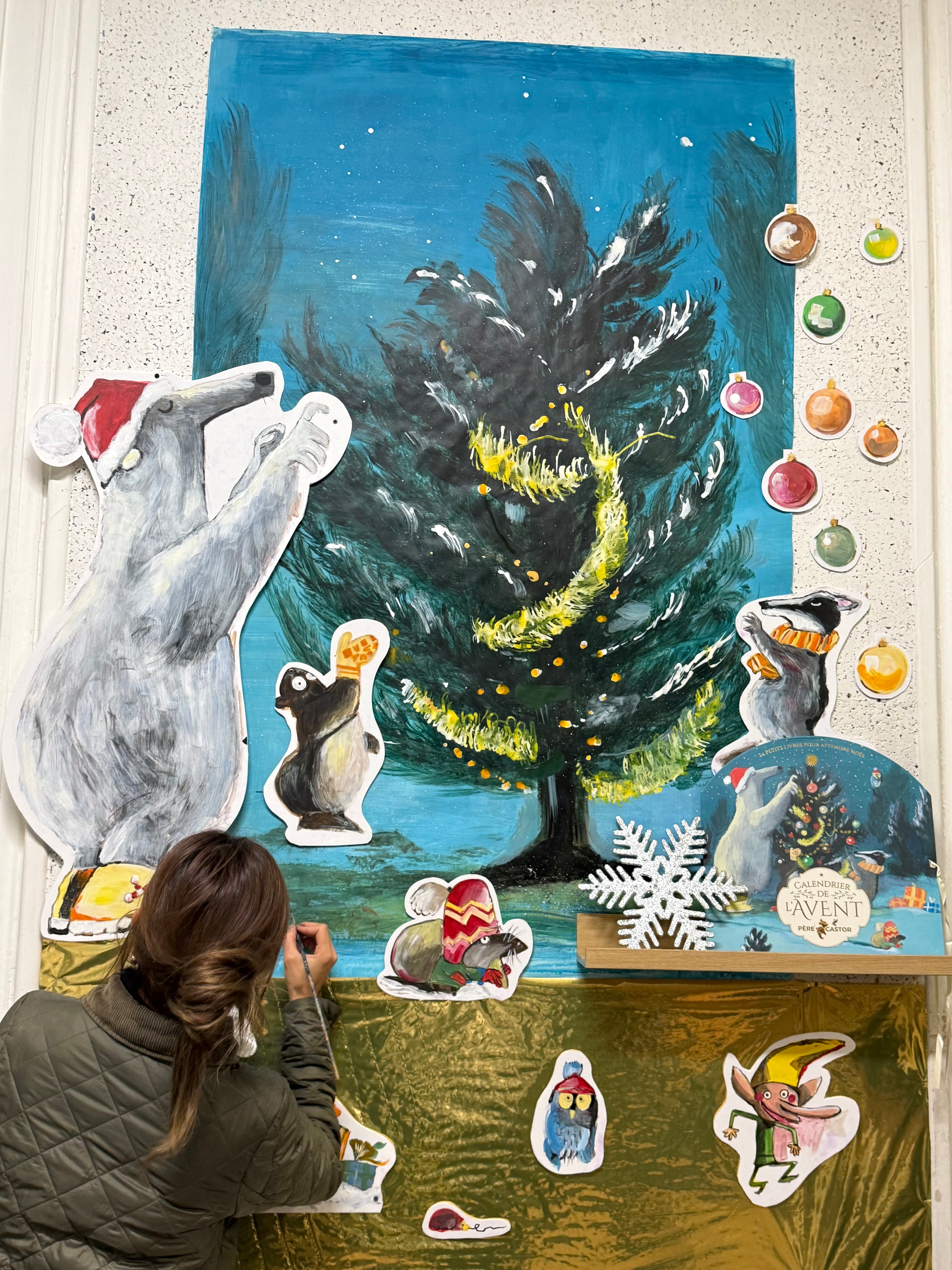 Panicha Thisanon painting a storybook-inspired mural at a primary school in Paris